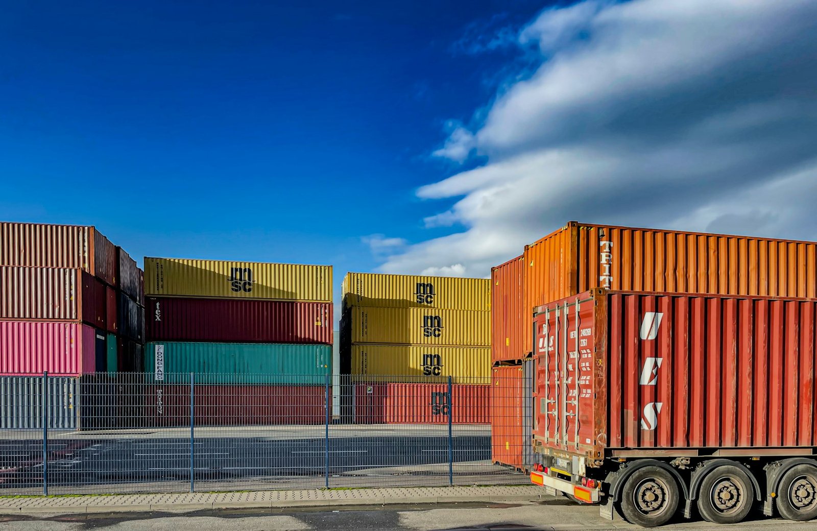Truck in front of shipping containers