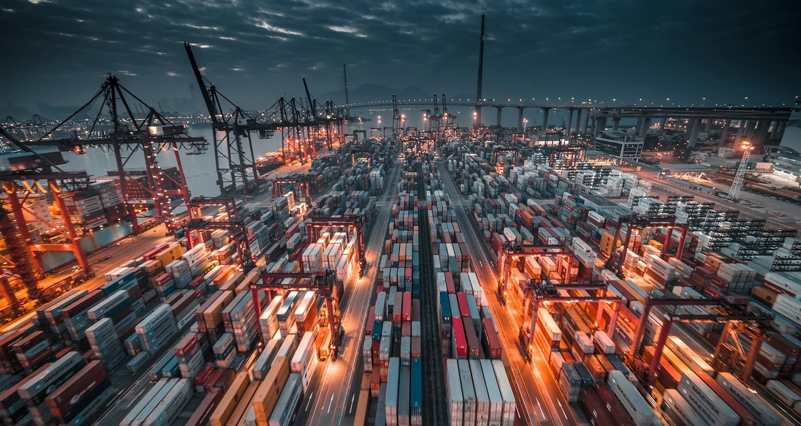 Port with stacked containers and cranes
